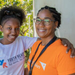 Jóvenes dominicanas sonrientes, destacando la importancia de la participación juvenil en la toma de decisiones para el desarrollo de sus comunidades, en el contexto del Día Internacional de la Juventud.